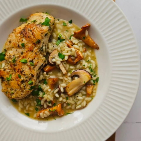 Mushroom risotto with crispy skin-on chicken breast steak